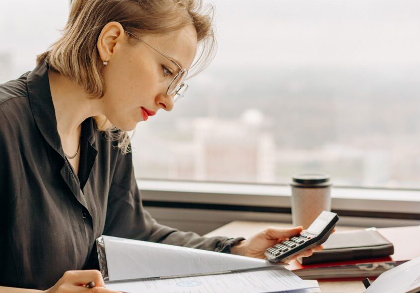 Bookkeeping professional reviewing financial records and calculating business expenses